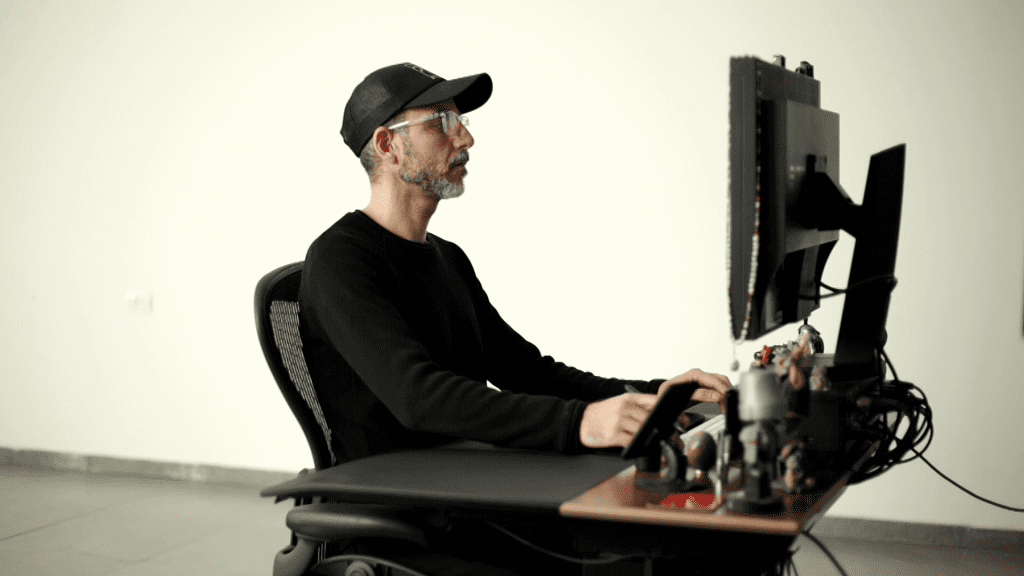 Ivan Moshe retouching at a two-monitor workstation in the studio, working with a graphics tablet, from the second Earrings Retouching lesson of the course.