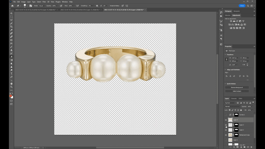 A gold pearl ring isolated on a transparent checkerboard background in Photoshop during the third Ring Retouching lesson, after the background has been removed with a path-based selection.