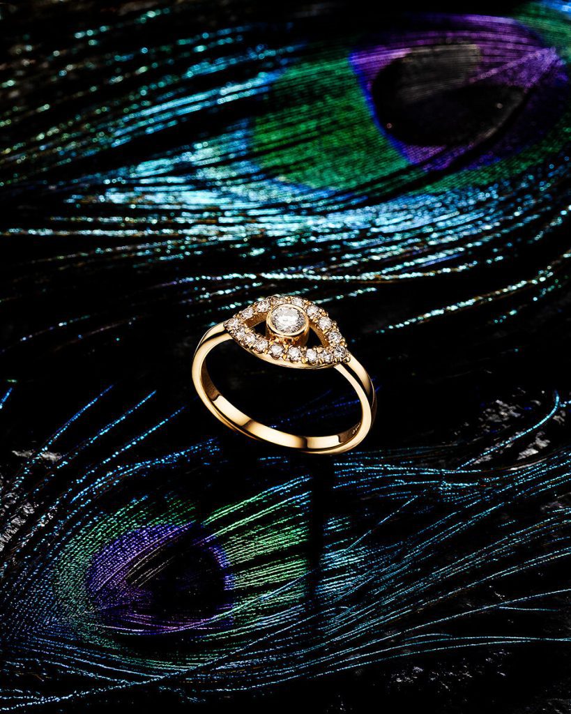 Gold ring on a peacock feather